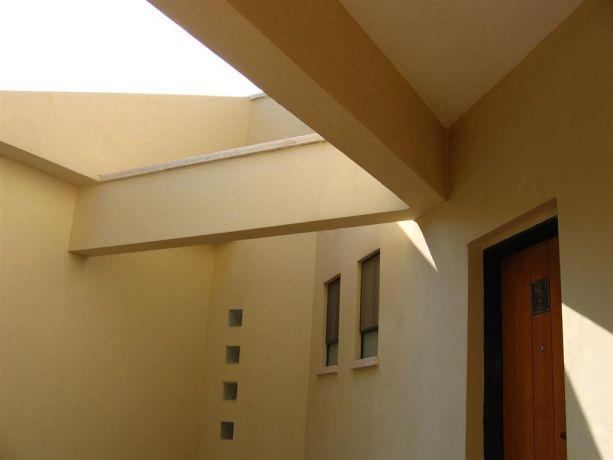 חזית בית ומבט לכניסה בדגש על חלונות אור. עיצוב ותכנון של ענת חיימוביץ אבישר